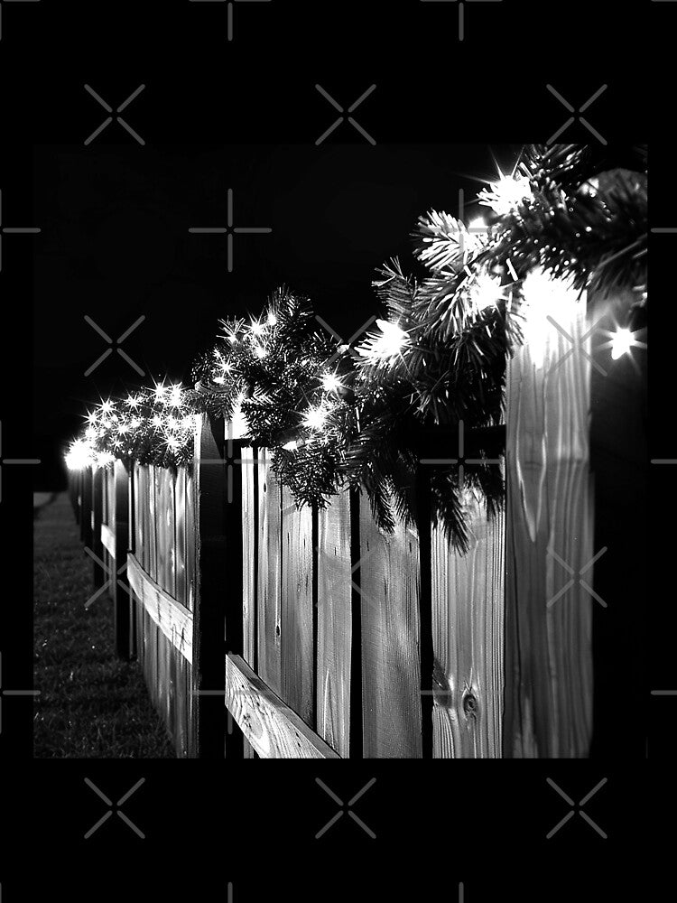 Christmas Lights and Evergreen Garland on Rustic Wooden Fence by inkoutninja