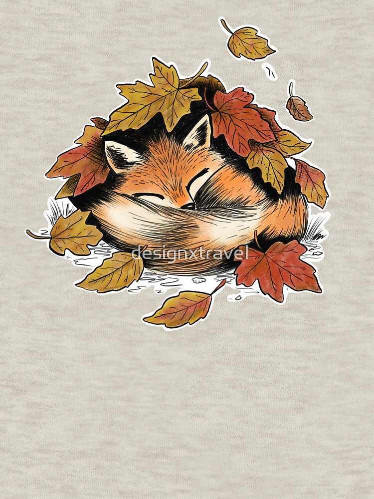 A cute cozy fox sleeping under a pile of leaves by designxtravel