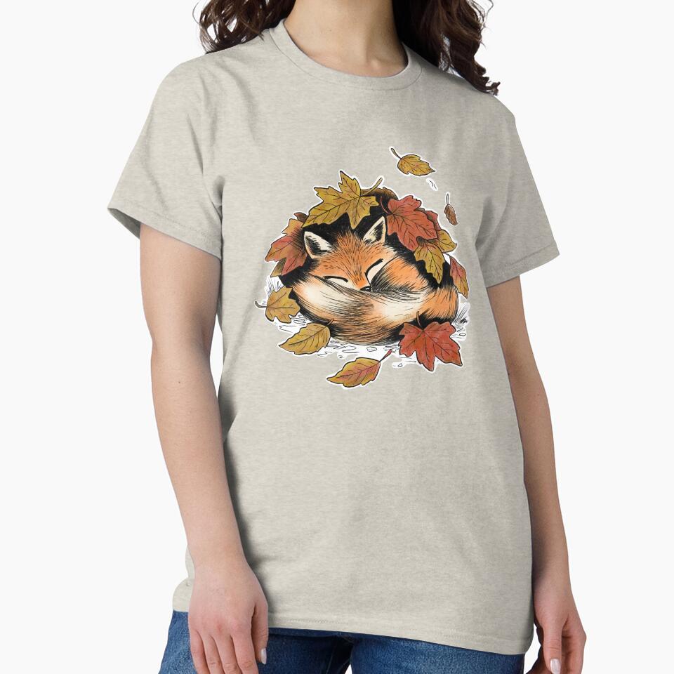 A cute cozy fox sleeping under a pile of leaves by designxtravel
